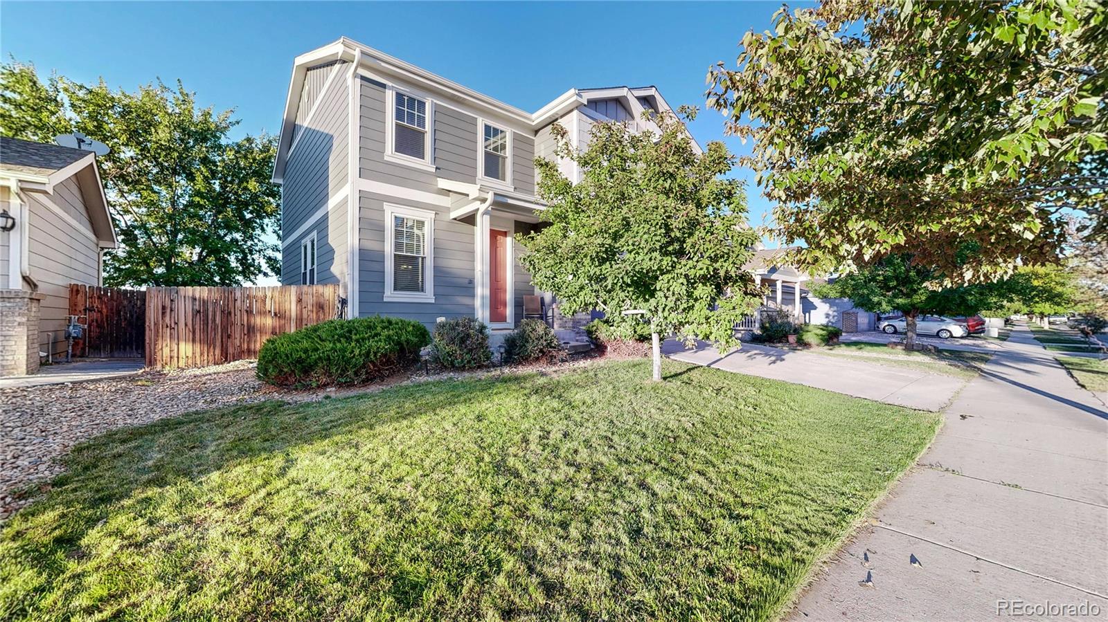 16159 Randolph Place Denver, CO 80239 - Photo 25 of 37 a front view of a house with a yard