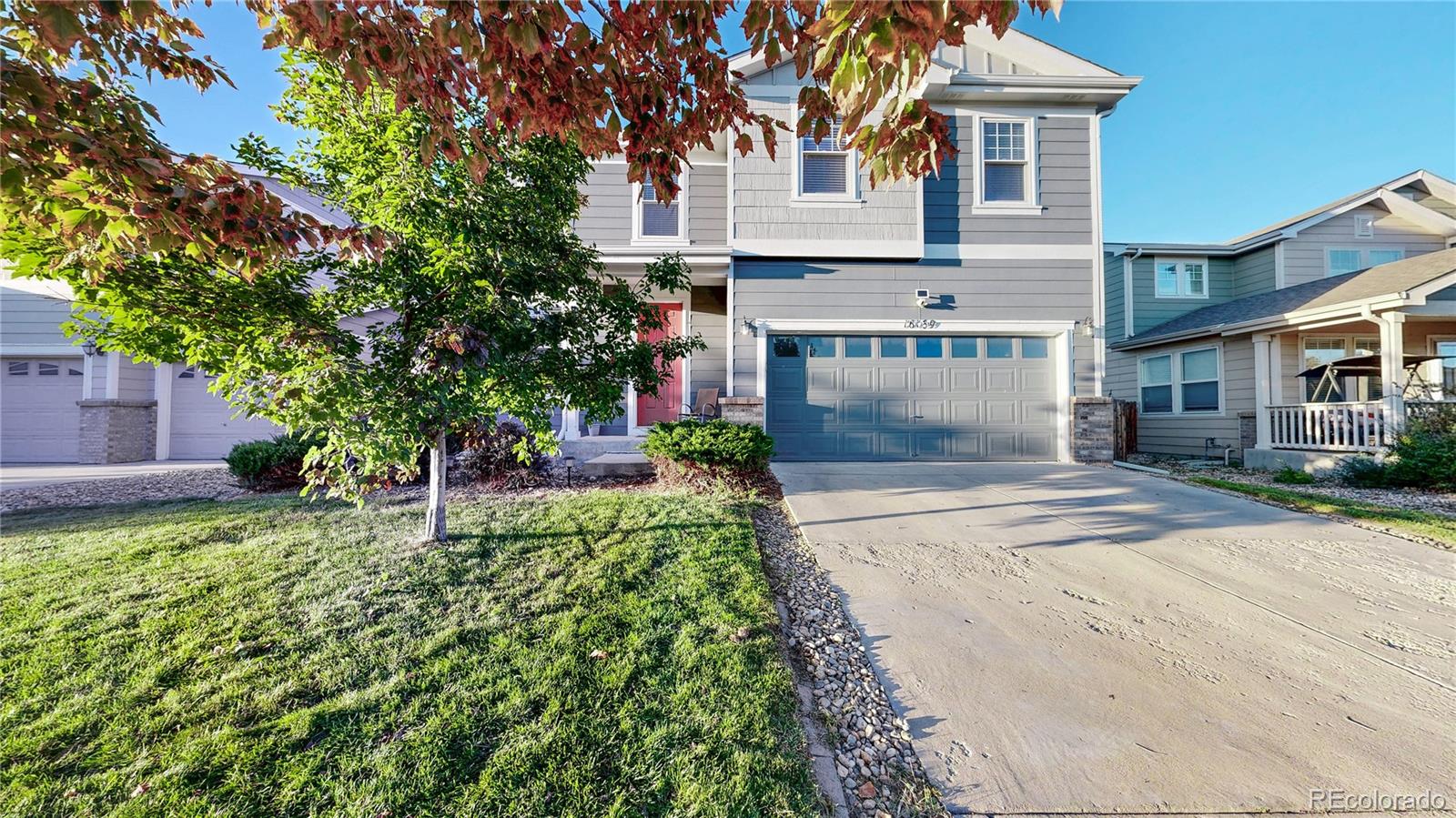 16159 Randolph Place Denver, CO 80239 - Photo 26 of 37 a front view of a house with a yard and garage