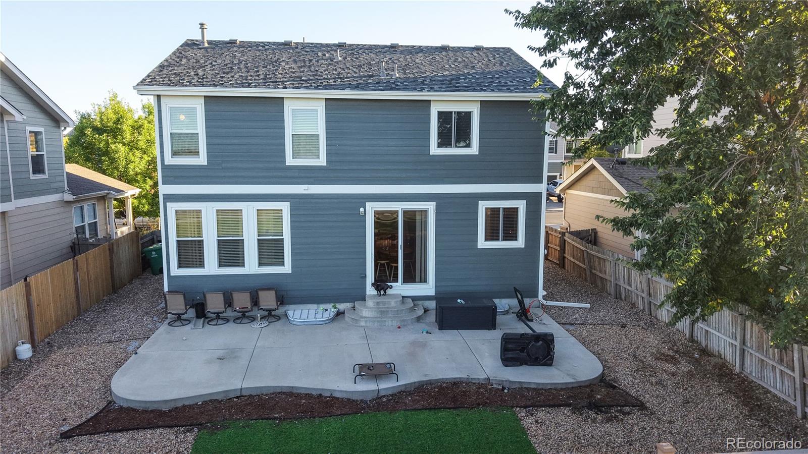 16159 Randolph Place Denver, CO 80239 - Photo 30 of 37 a front view of a house with garden and porch