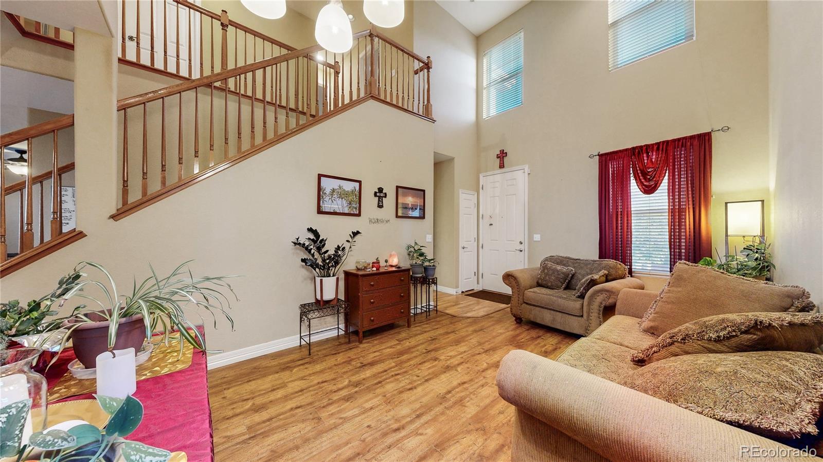 16159 Randolph Place Denver, CO 80239 - Photo 4 of 37 a living room with furniture and wooden floor