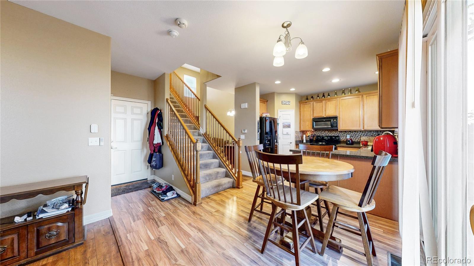 16159 Randolph Place Denver, CO 80239 - Photo 7 of 37 a view of a dining room with furniture and wooden floor