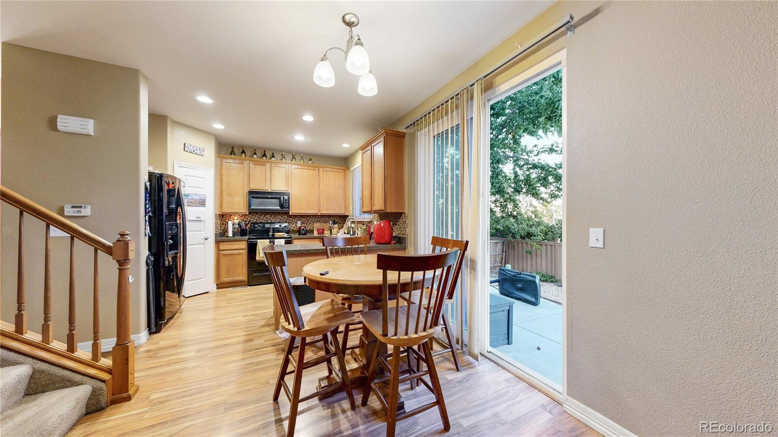 16159 Randolph Place Denver, CO 80239 - Photo 8 of 37 a view of a dining room with furniture window and wooden floor