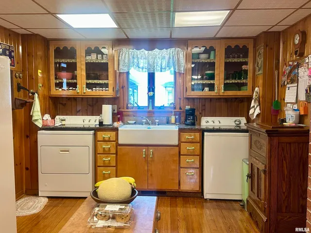 a kitchen with stainless steel appliances granite countertop wooden floors and sink