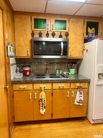 a kitchen with stainless steel appliances granite countertop a stove and a microwave