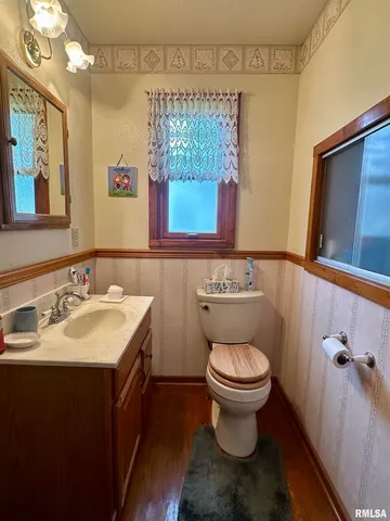 a bathroom with a sink toilet and mirror