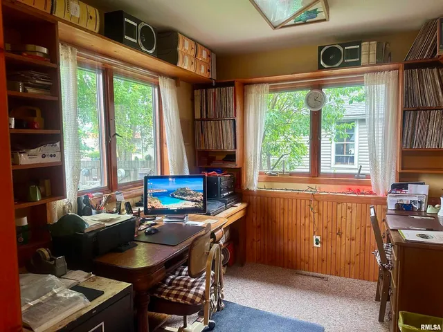 a workspace with furniture and a window