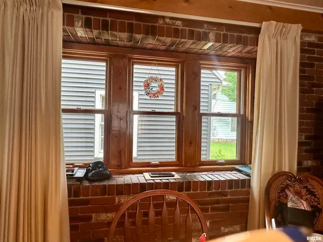 a dining room with furniture and window