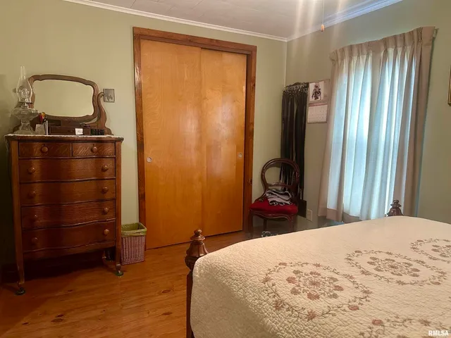 a bedroom with a bed and a mirror