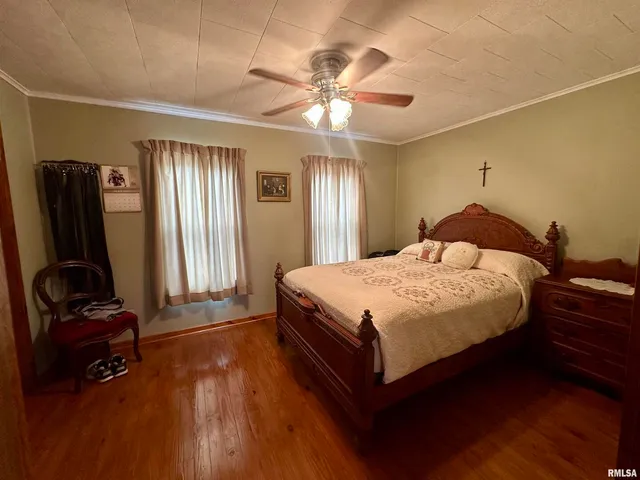 a room with a bed and a mirror on the dresser