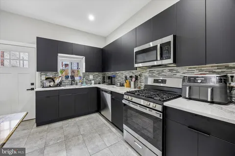 a kitchen with a stove and a microwave