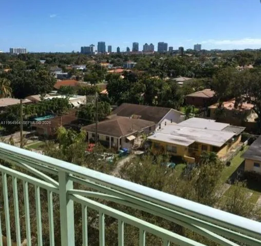 a view of a balcony with wooden floor and city view
