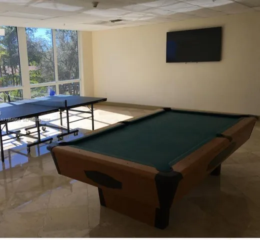 a living room with chair and a flat screen tv