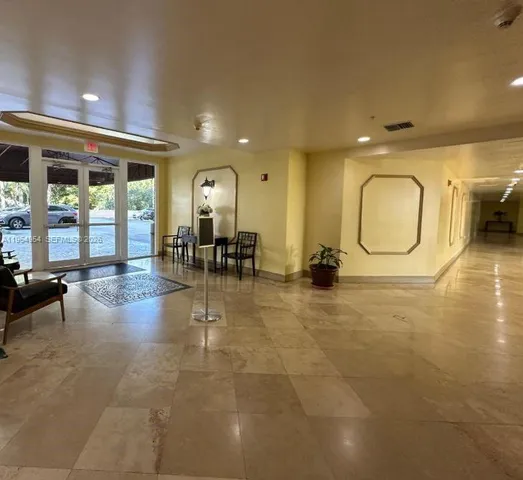 a lobby with furniture and a large window