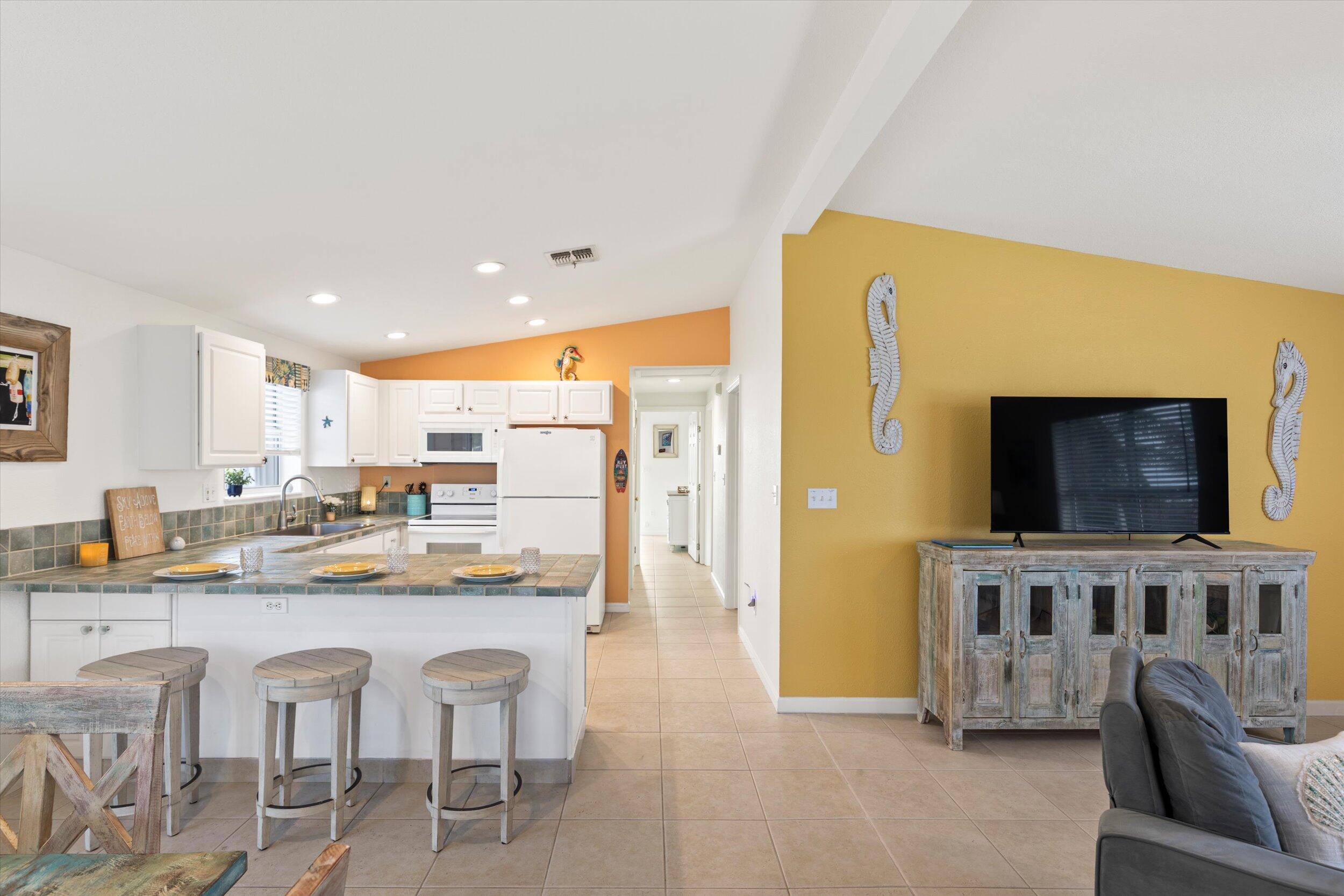 157 Mars Lane Key West, FL 33040 - Photo 15 of 41 a dining room with furniture and a flat screen tv