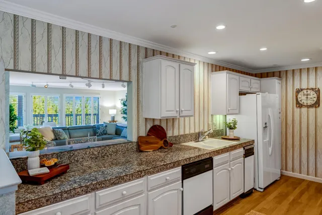 a kitchen with stainless steel appliances granite countertop a sink and a granite counter tops