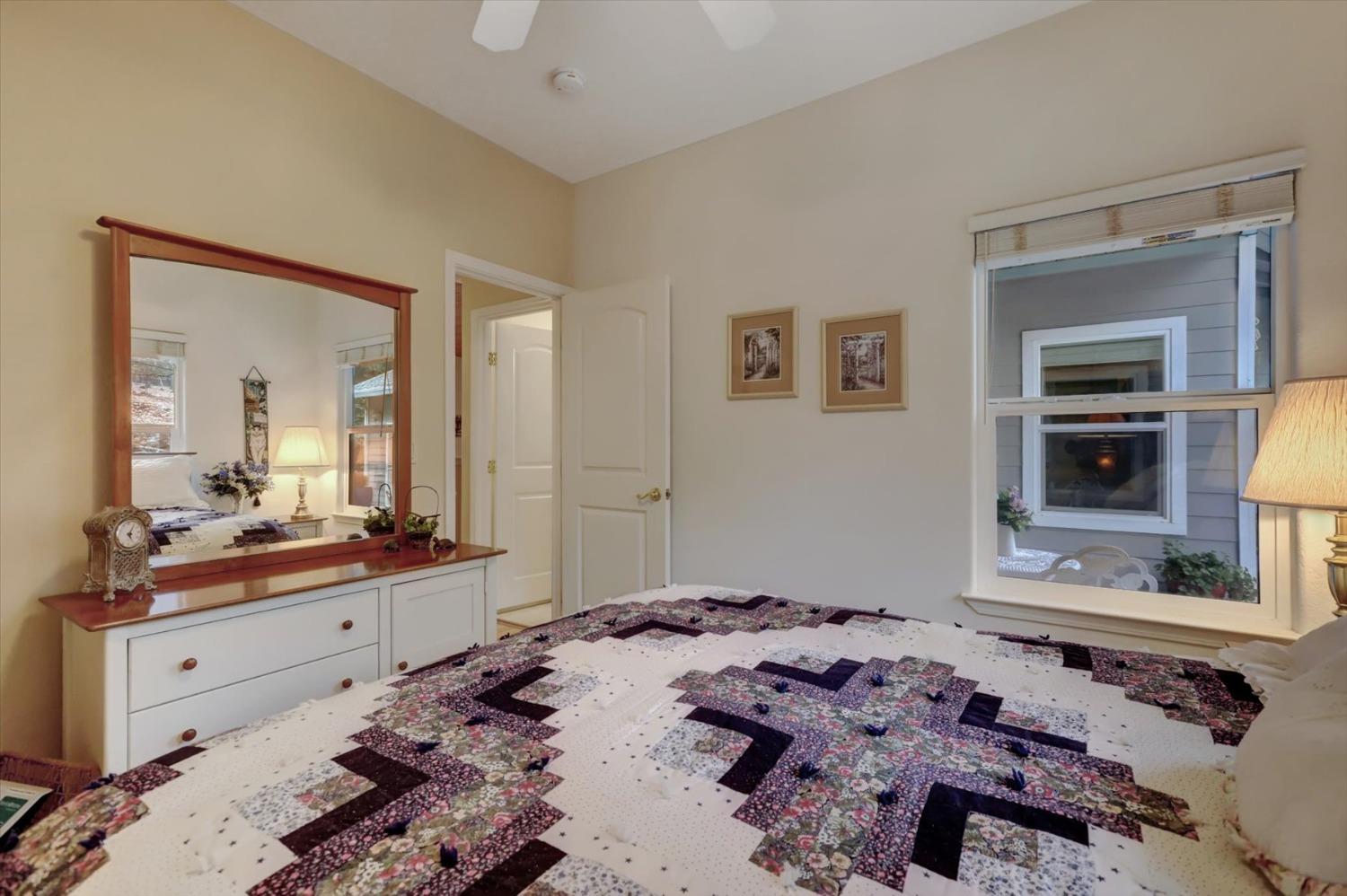 17036 Alice Way Grass Valley, CA 95949 - Photo 28 of 58 a bedroom with a bed and a mirror on dresser