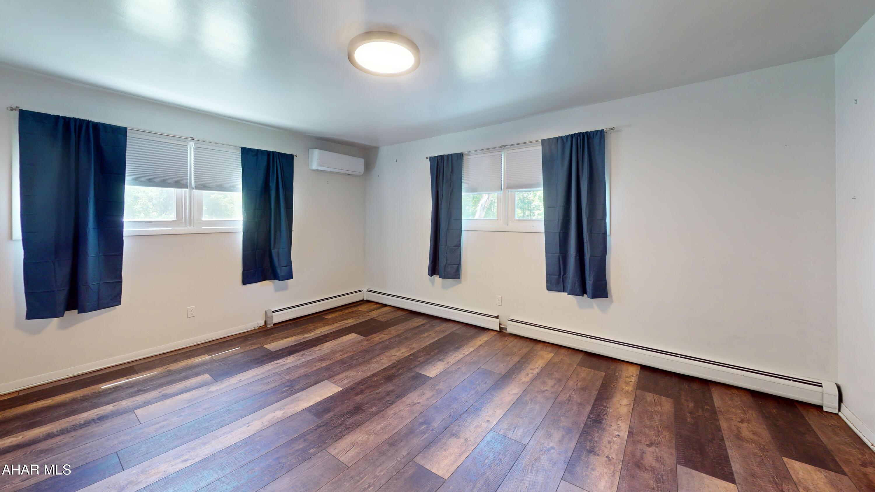 871 Decker Hollow Road Tyrone, PA 16686 - Photo 27 of 35 an empty room with wooden floor and windows