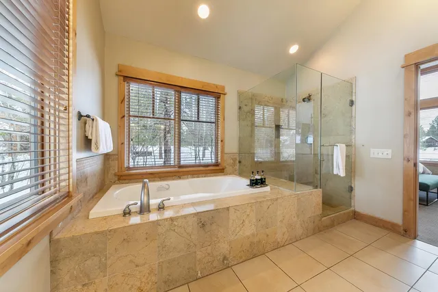a spacious bathroom with a tub sink and shower