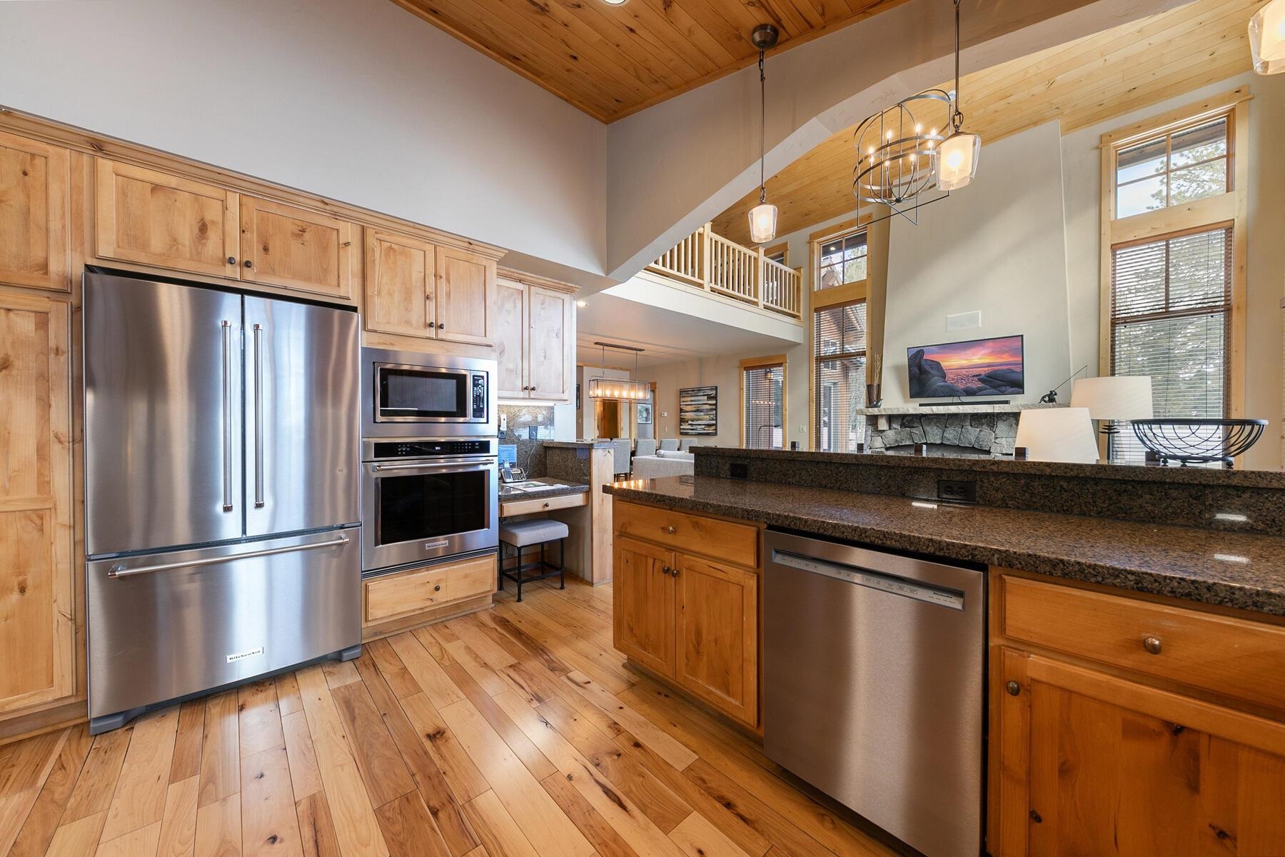 12339 Lookout Loop, Unit F0638 Truckee, CA 96161 - Photo 2 of 27 a kitchen with stainless steel appliances wooden floor sink and wooden cabinets