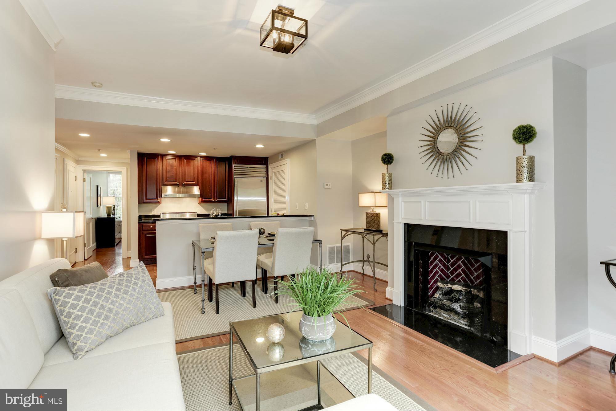 3318 Volta Place Northwest, Unit 2 Washington, DC 20007 - Photo 11 of 30 a living room with furniture and a fireplace