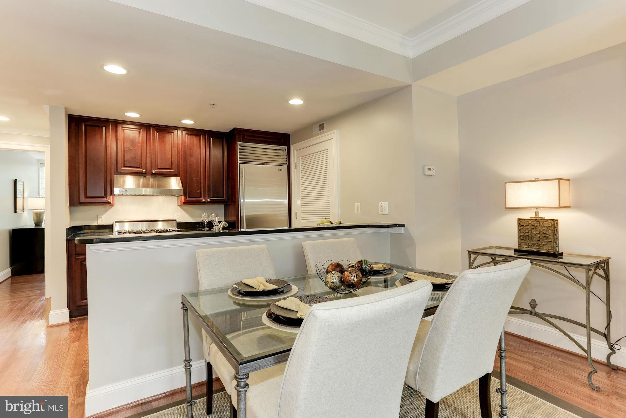 3318 Volta Place Northwest, Unit 2 Washington, DC 20007 - Photo 14 of 30 a kitchen with a table chairs stove and microwave