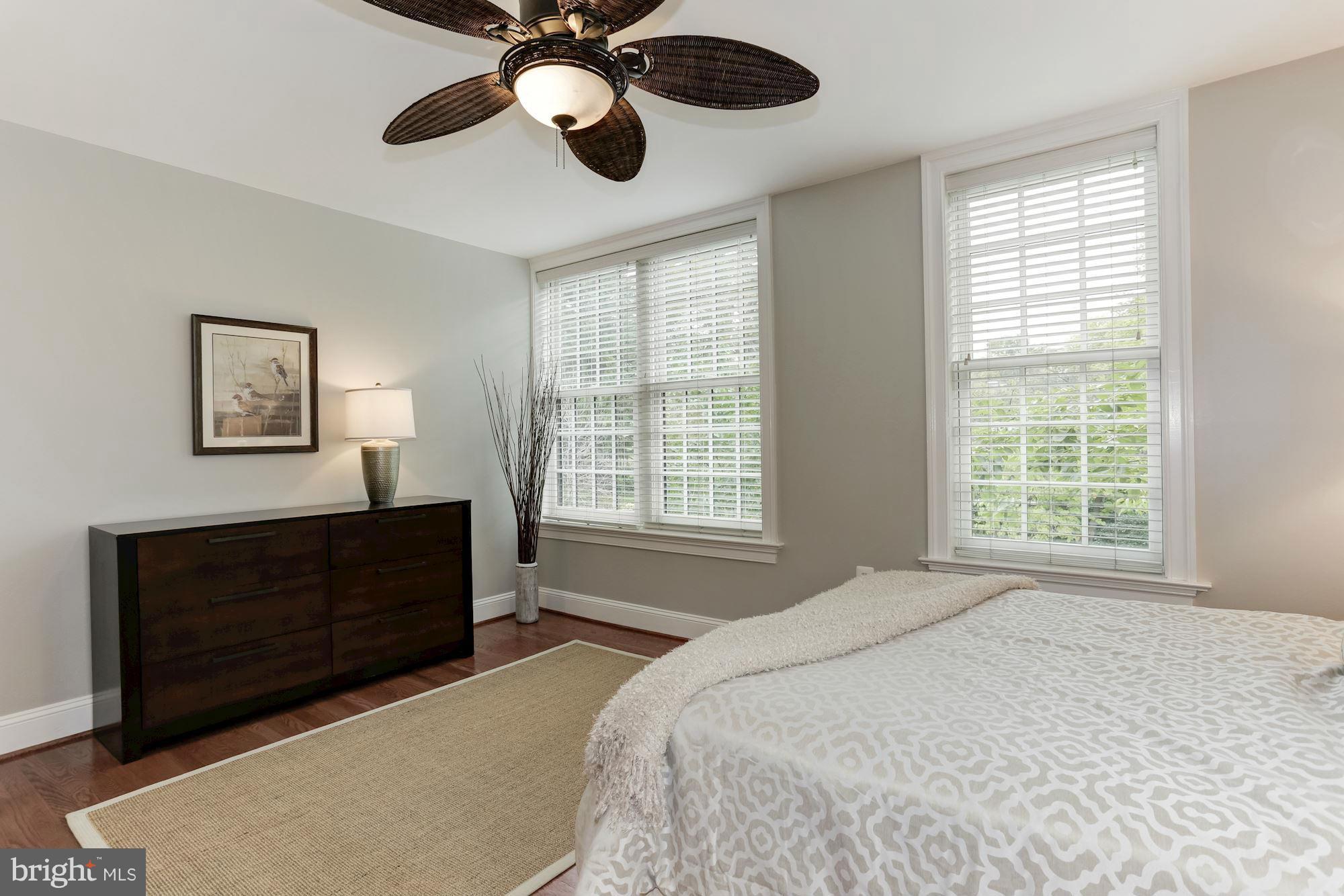 3318 Volta Place Northwest, Unit 2 Washington, DC 20007 - Photo 23 of 30 a spacious bedroom with a bed and a chandelier