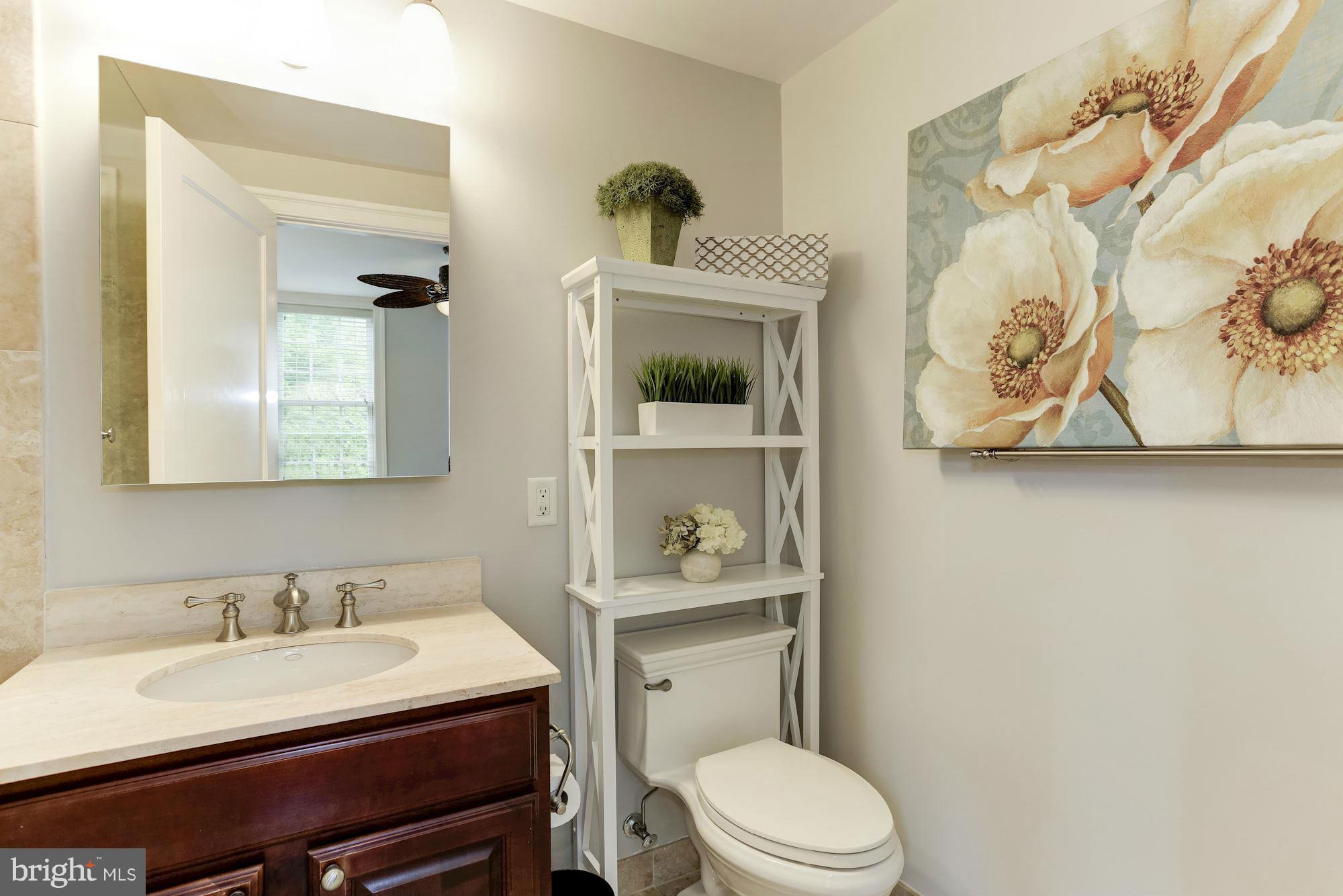 3318 Volta Place Northwest, Unit 2 Washington, DC 20007 - Photo 24 of 30 a bathroom with a granite countertop sink mirror vanity and toilet