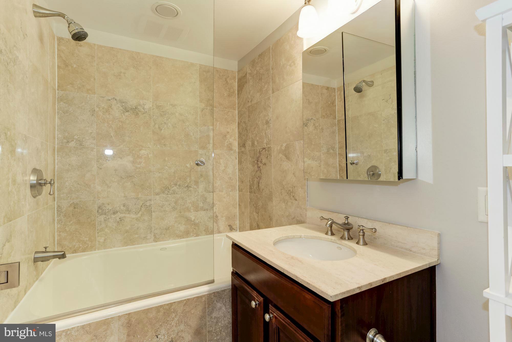 3318 Volta Place Northwest, Unit 2 Washington, DC 20007 - Photo 25 of 30 a bathroom with a sink and a mirror