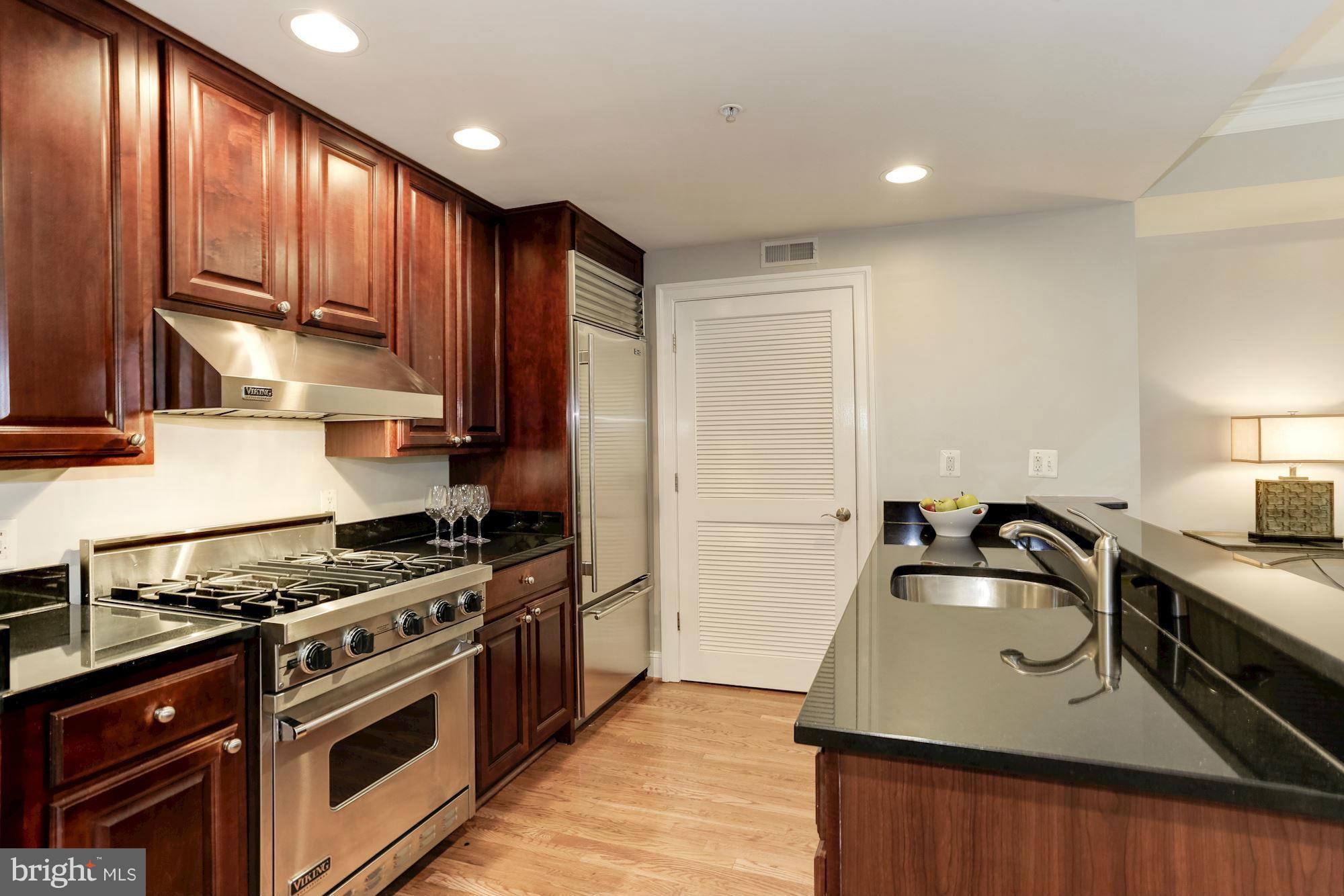 3318 Volta Place Northwest, Unit 2 Washington, DC 20007 - Photo 6 of 30 a kitchen with granite countertop a sink stainless steel appliances and cabinets