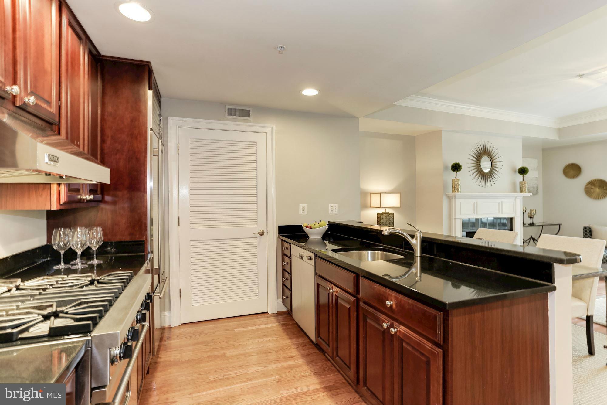 3318 Volta Place Northwest, Unit 2 Washington, DC 20007 - Photo 7 of 30 a kitchen that has a sink and a stove
