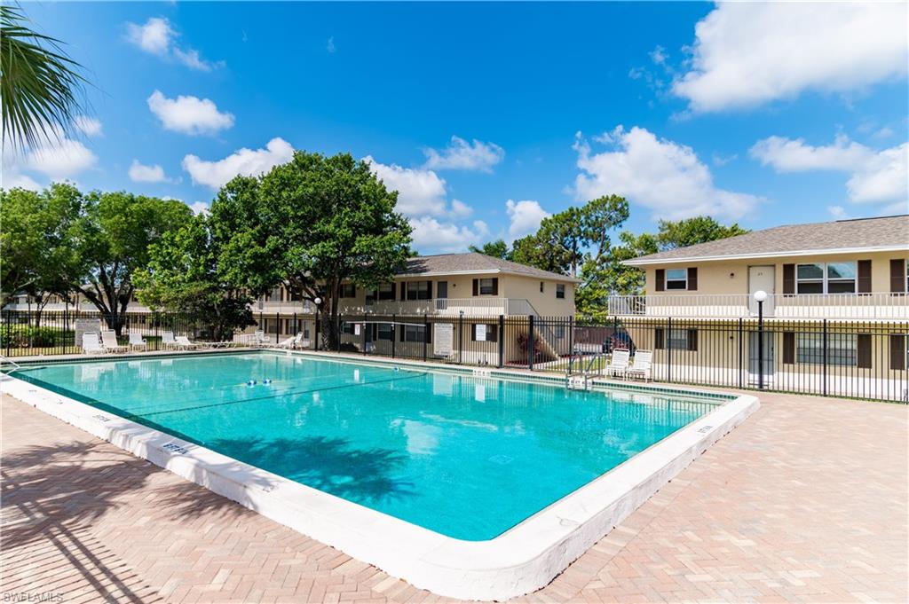 3325 Airport Road North, Unit T1 Naples, FL 34105 - Photo 17 of 19 a view of a house with a swimming pool