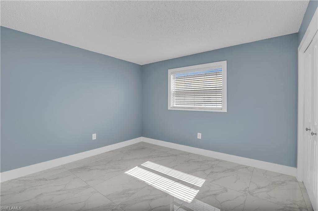3325 Airport Road North, Unit T1 Naples, FL 34105 - Photo 4 of 19 a view of an empty room with a window