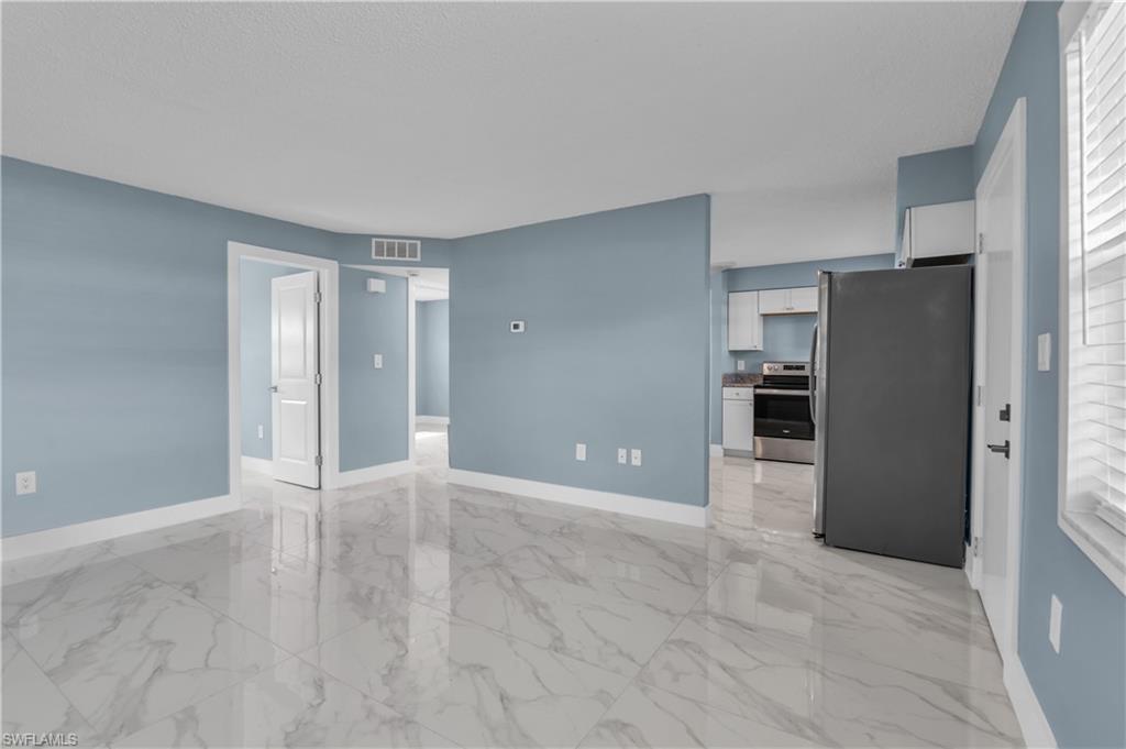 3325 Airport Road North, Unit T1 Naples, FL 34105 - Photo 6 of 19 a view of a kitchen with refrigerator and an oven