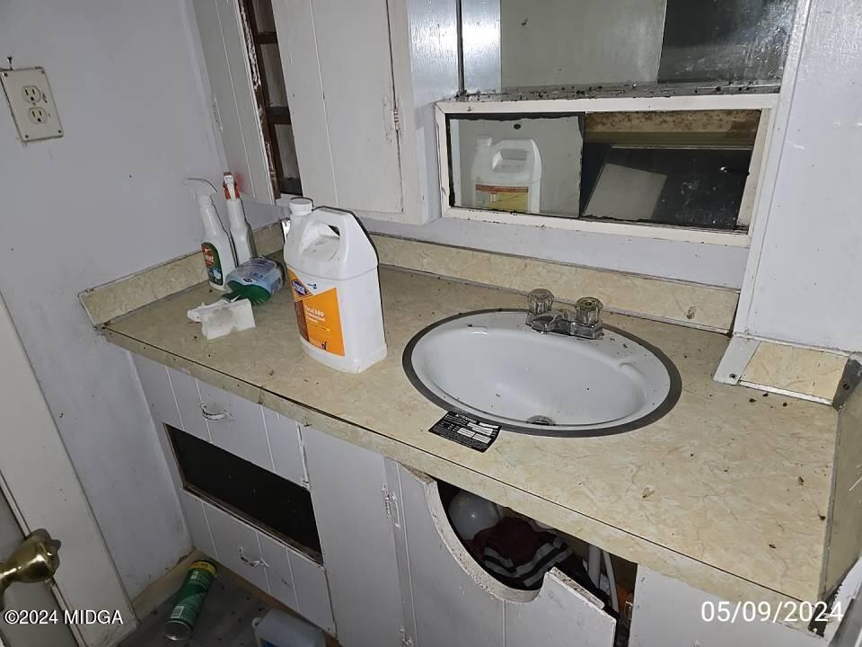 1627 Upper River Road Macon, GA 31211 - Photo 12 of 23 a bathroom with a sink and a mirror