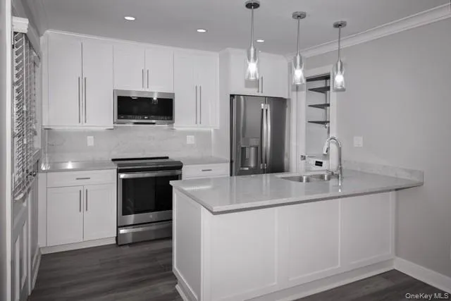 a kitchen with stainless steel appliances a refrigerator sink and microwave