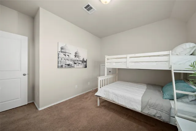a bedroom with a bed and white walls