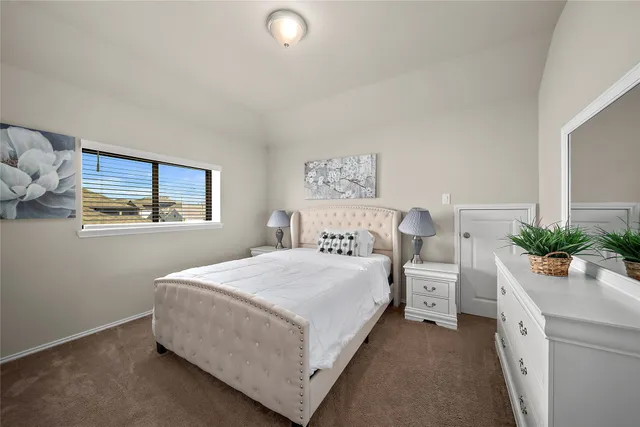 a bedroom with a bed and window