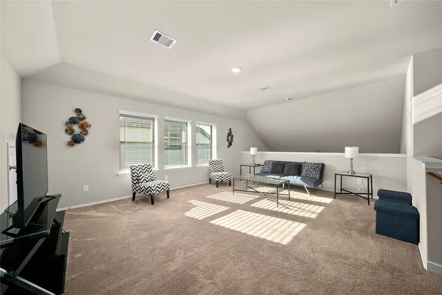 a living room with furniture a flat screen tv and a large window