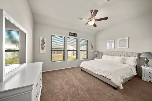 a spacious bedroom with a large bed and a large window