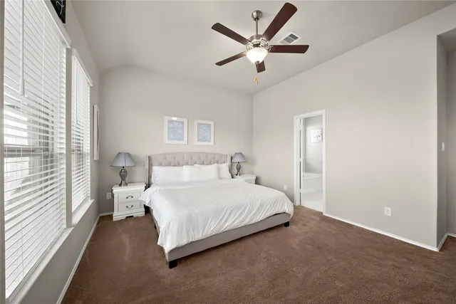 a bedroom with a large bed and a large window