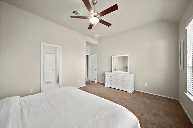 a bedroom with a white bed and a chandelier