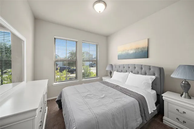 a bedroom with a bed and a large window