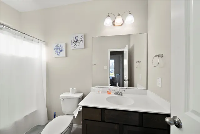 a bathroom with a sink a toilet and a mirror