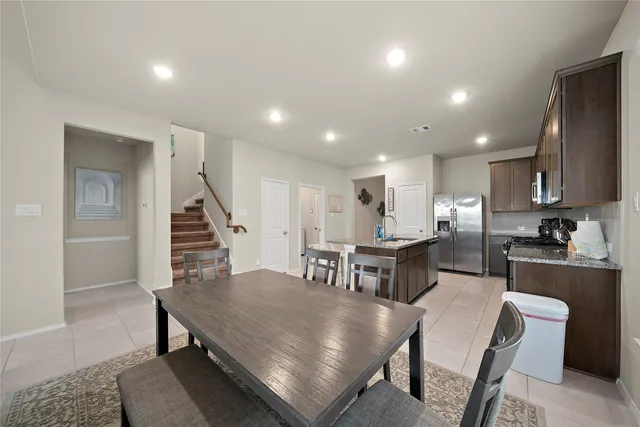a kitchen with a table and chairs in it