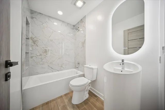 a bathroom with a sink toilet and shower