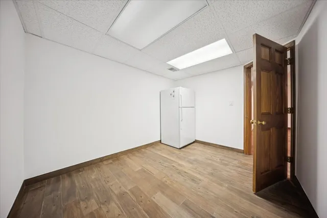 an empty room with wooden floor and closet