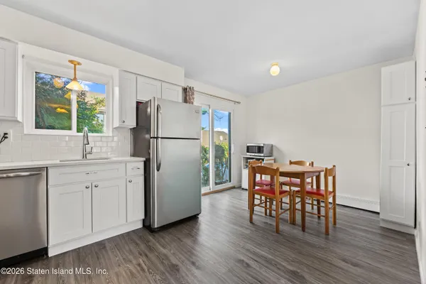 a kitchen with wooden floors and white appliances