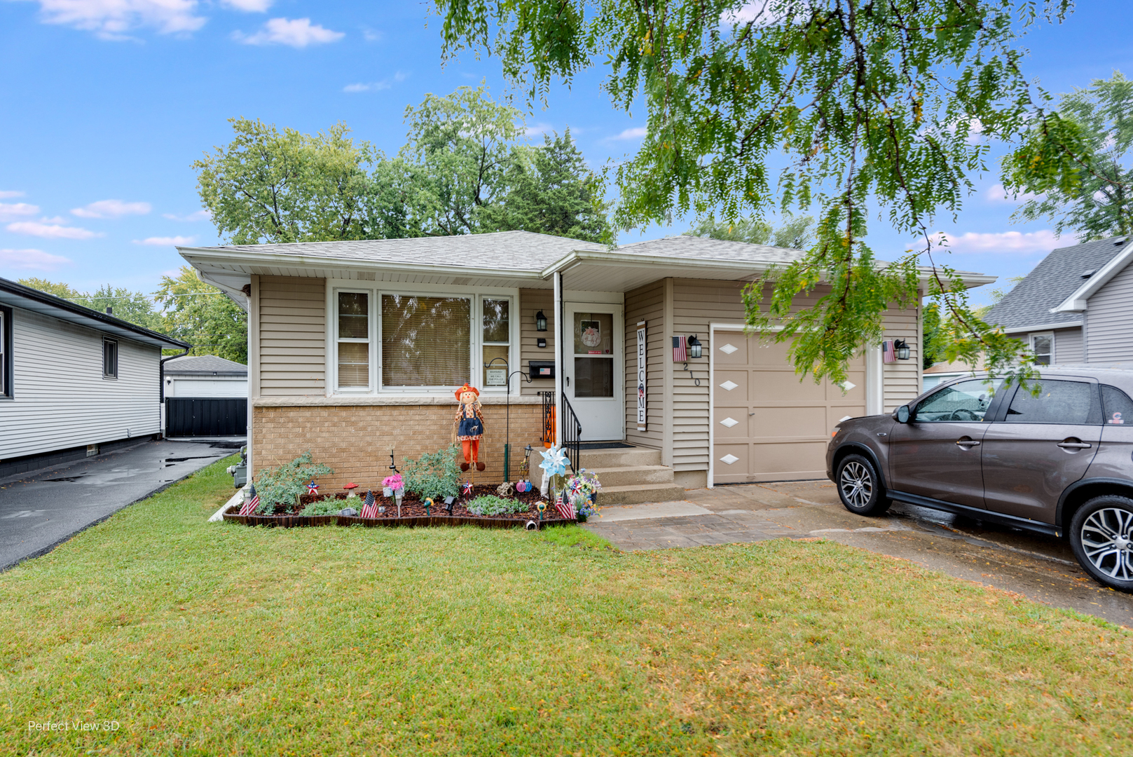 210 South Reed Street Joliet, IL 60436 - Photo 1 of 13 a front view of a house with a garden
