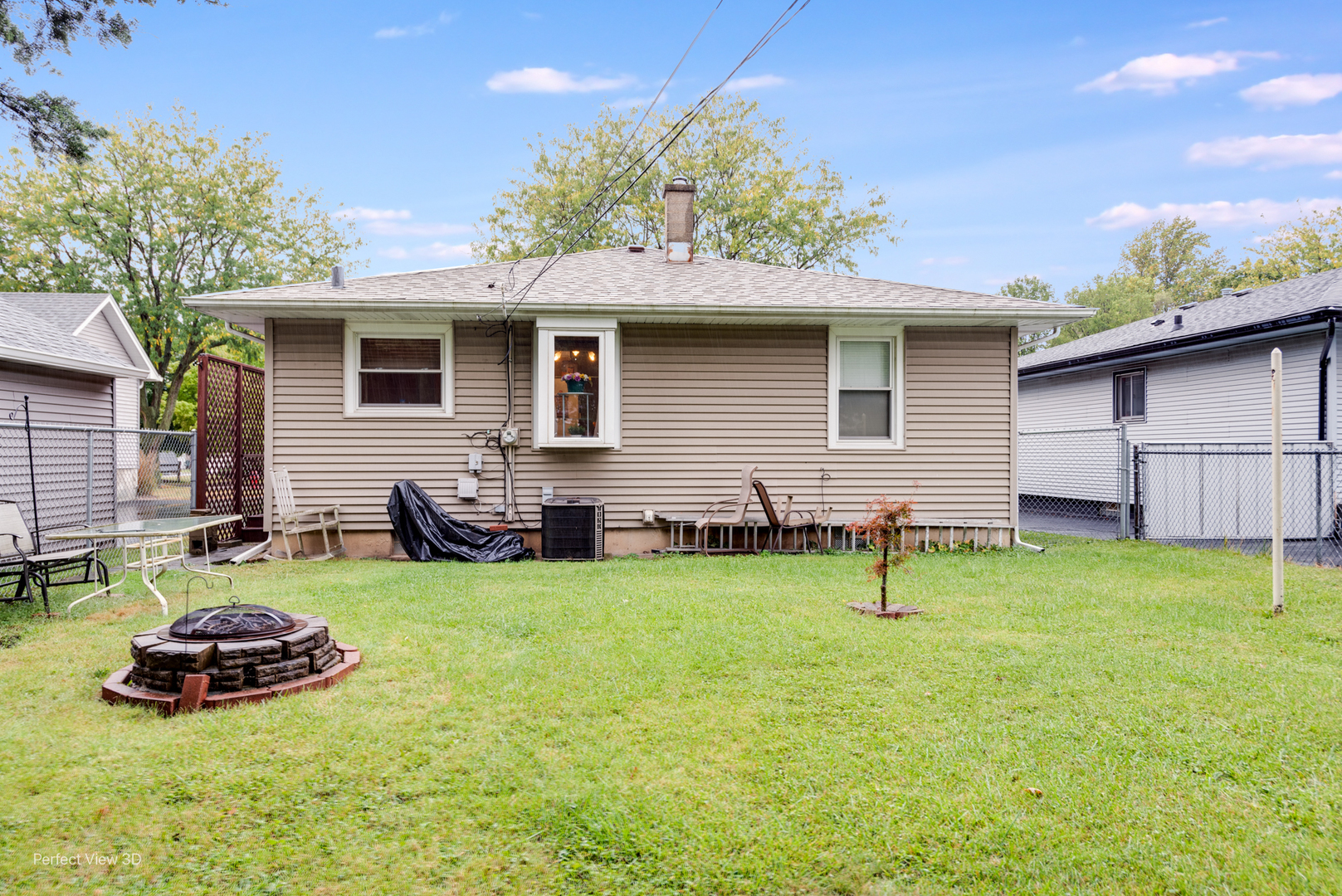 210 South Reed Street Joliet, IL 60436 - Photo 2 of 13 a backyard of a house with table and chairs