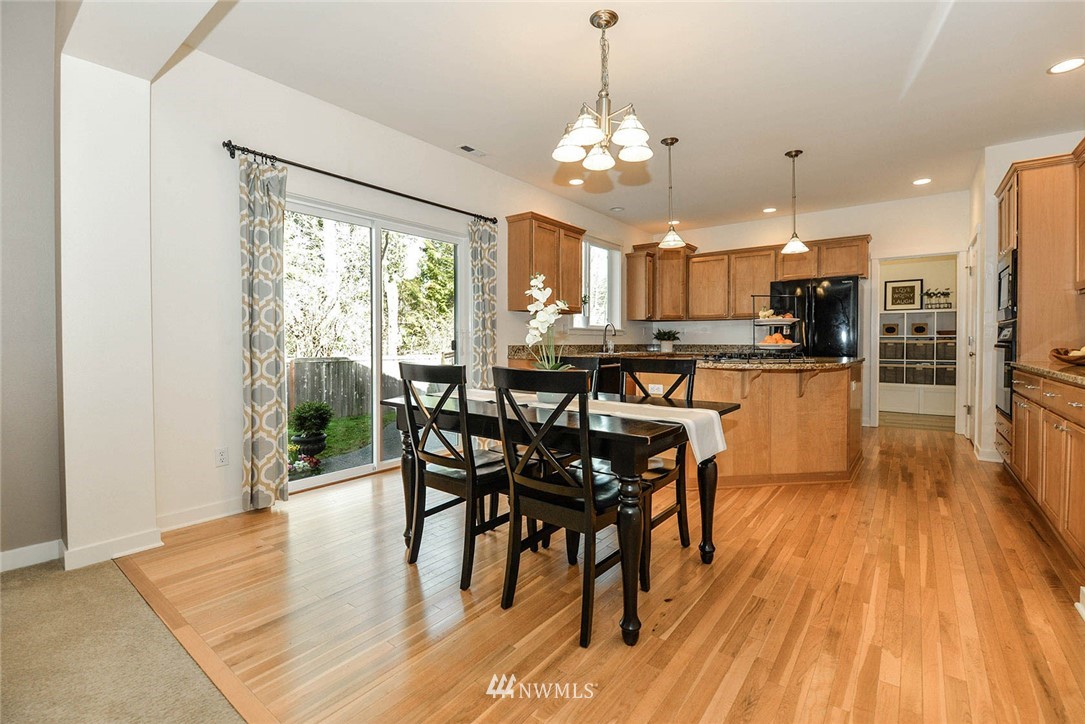21814 41st Avenue Southeast Bothell, WA 98021 - Photo 12 of 30 a view of a dining room with furniture window and wooden floor